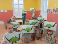 Dzieci z punktu przedszkolnego prezentują swoje papierowe dinozaury