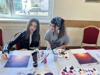 Uczestnicy warsztatów tworzący własne obrazy.