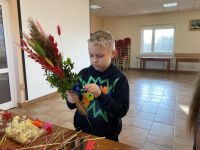 Uczestnicy zajęć tworzący własne palmy wielkanocne.